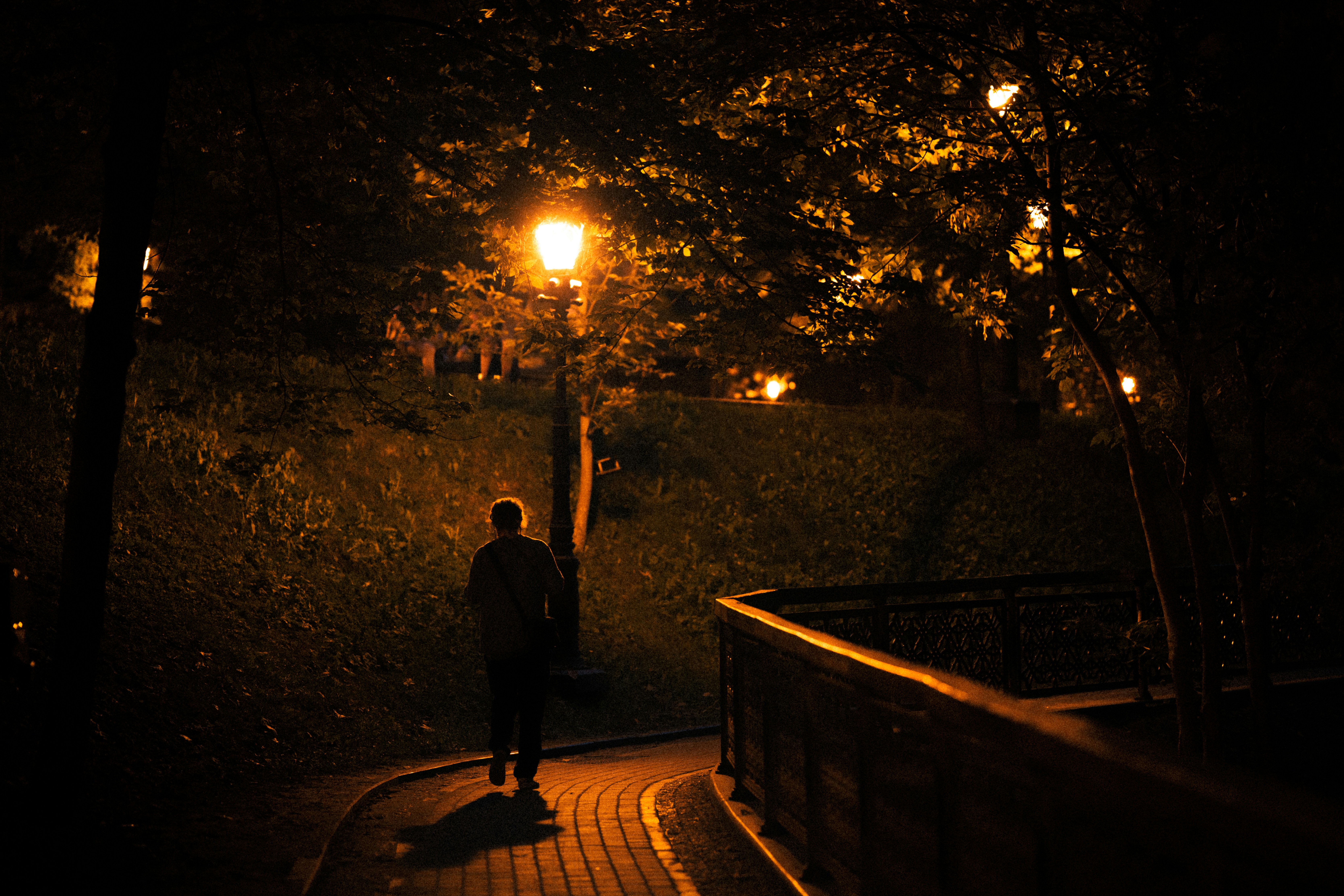 A person walking down a path at night photo – Free Light Image on Unsplash