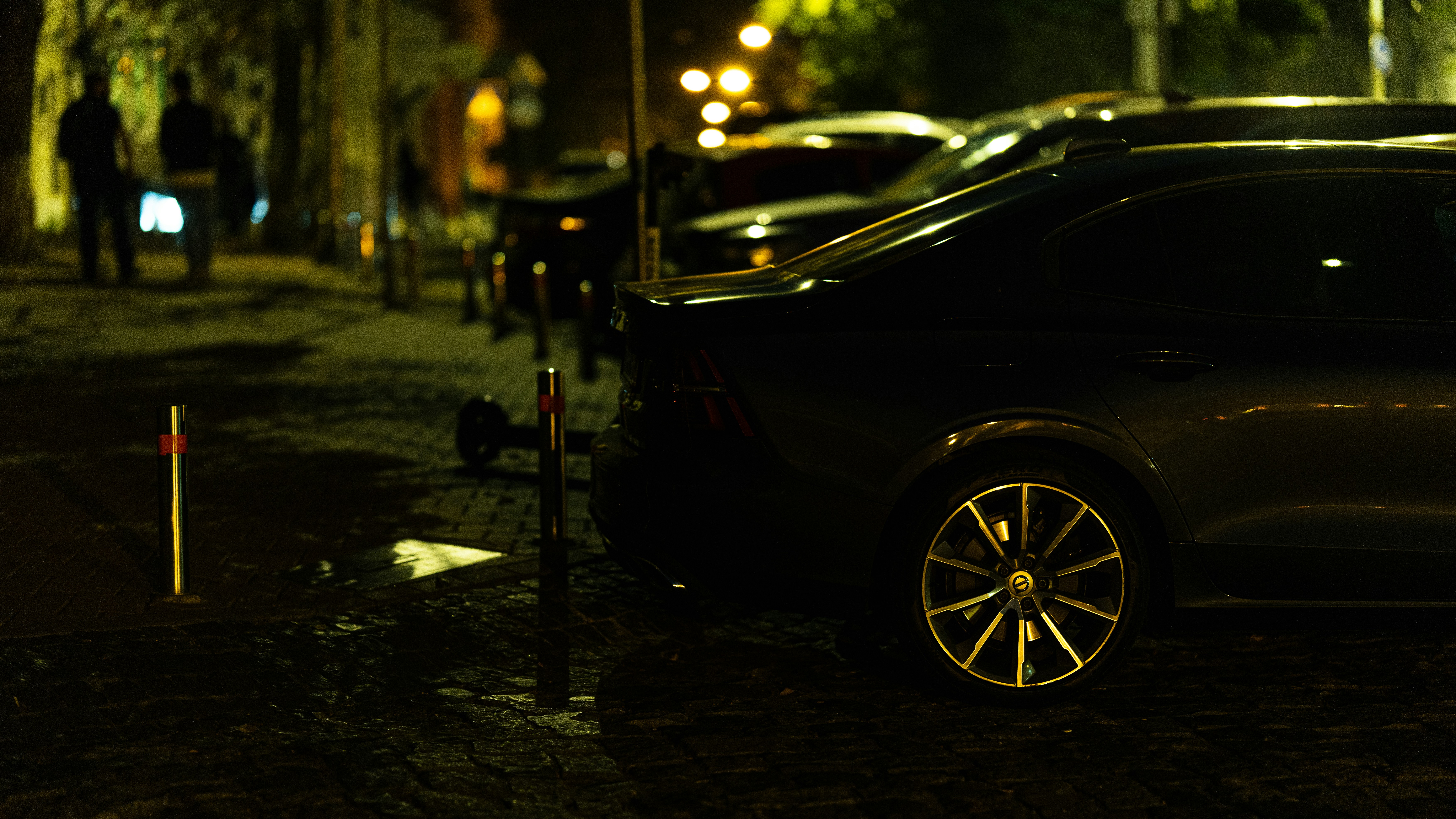 White sedan car parked on dark street with moody atmospheric lighting