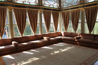 a living room with a couch and large windows