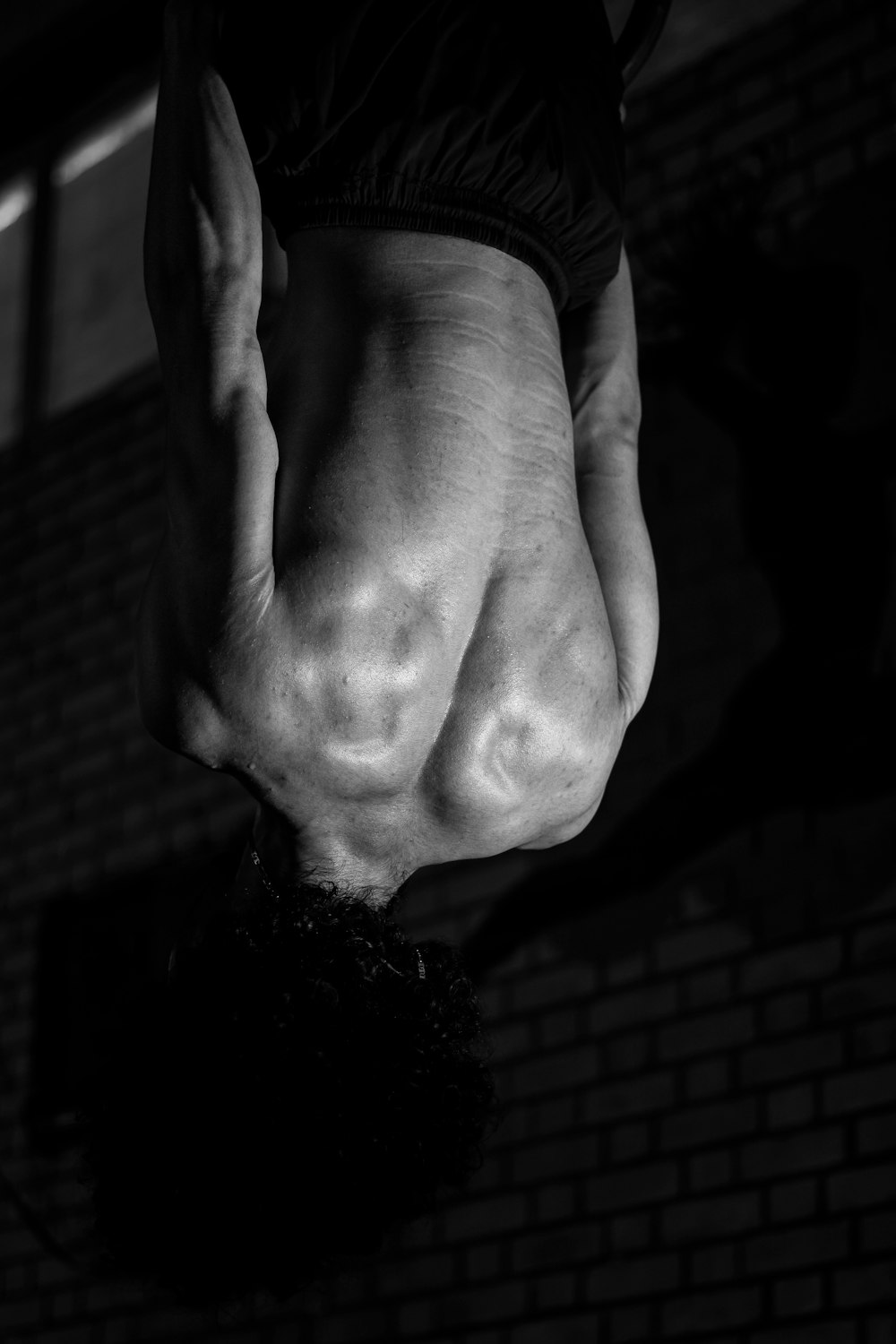 a black and white photo of a person upside down