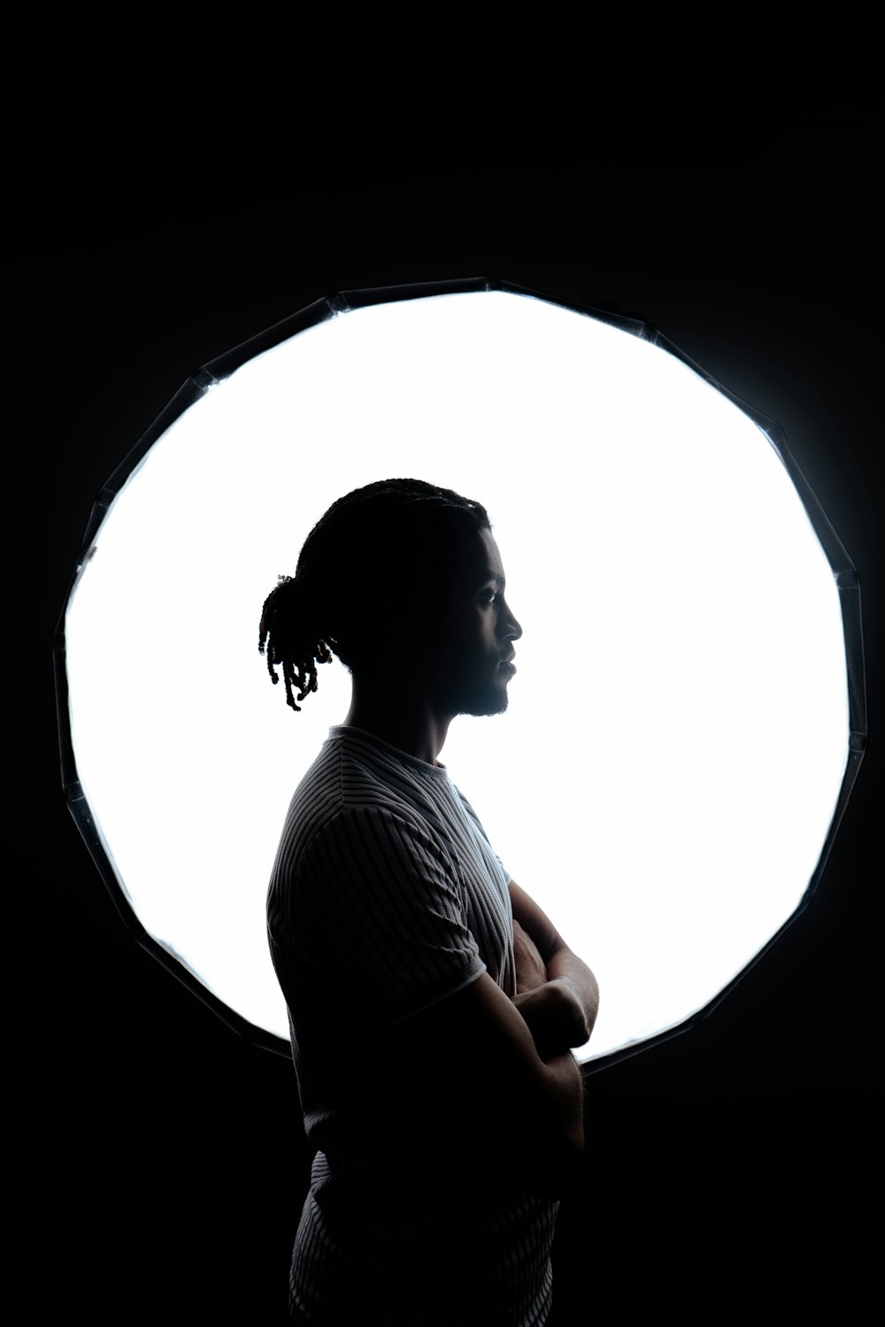 a woman standing in front of a circular light