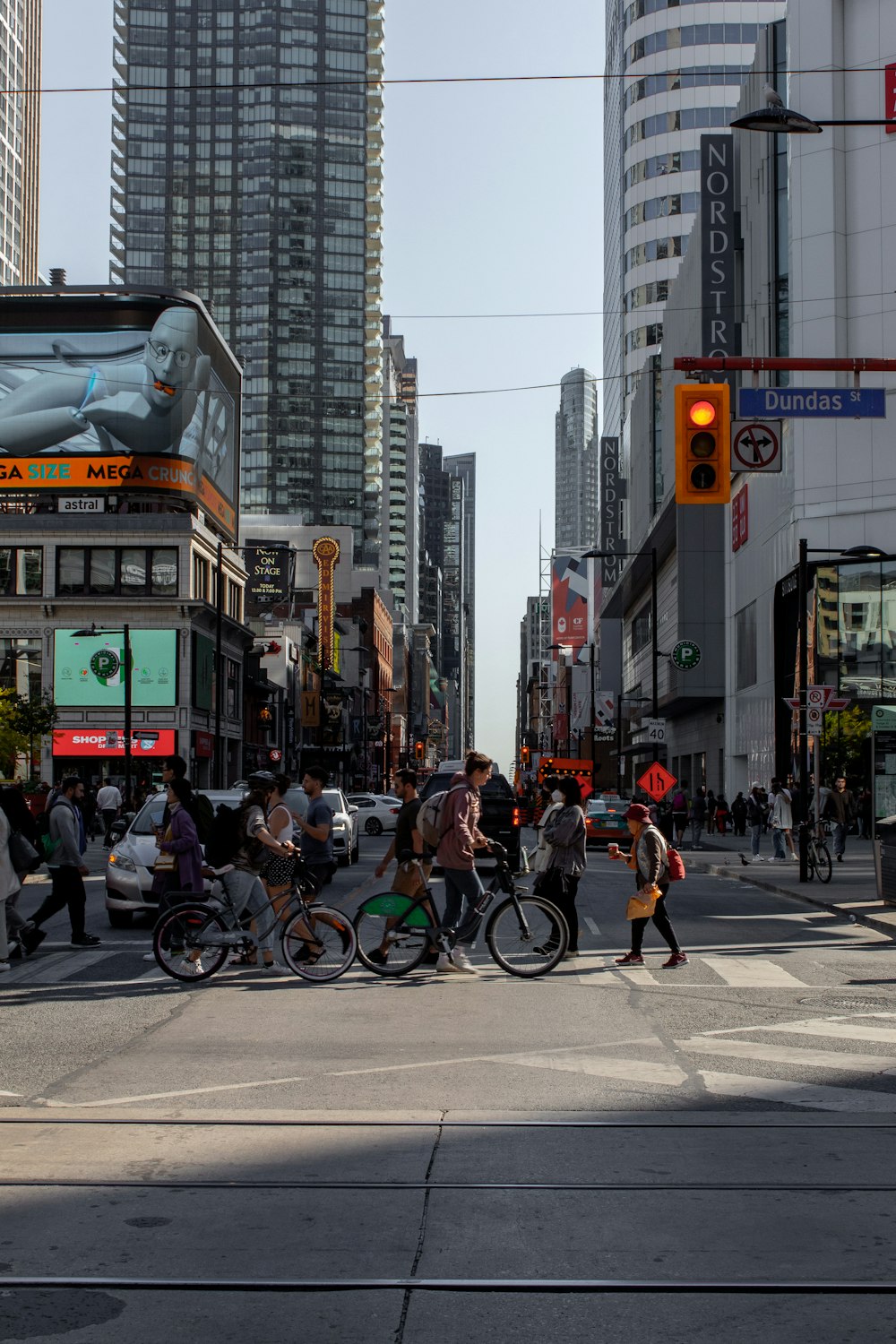 a group of people crossing a street in a city