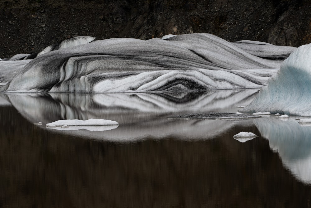 a large iceberg floating on top of a lake