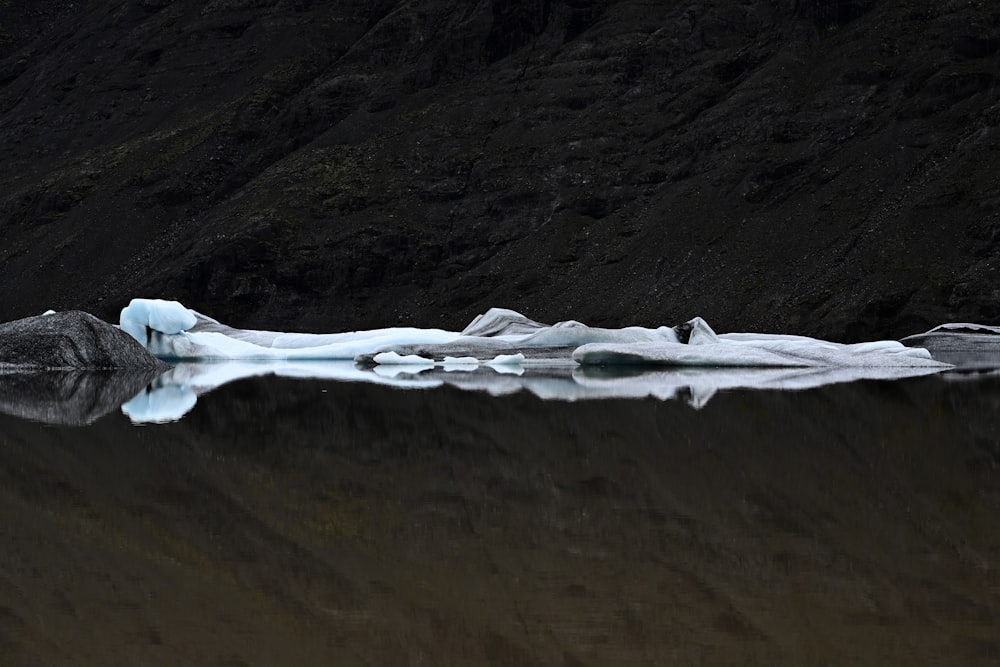 a large iceberg floating on top of a lake