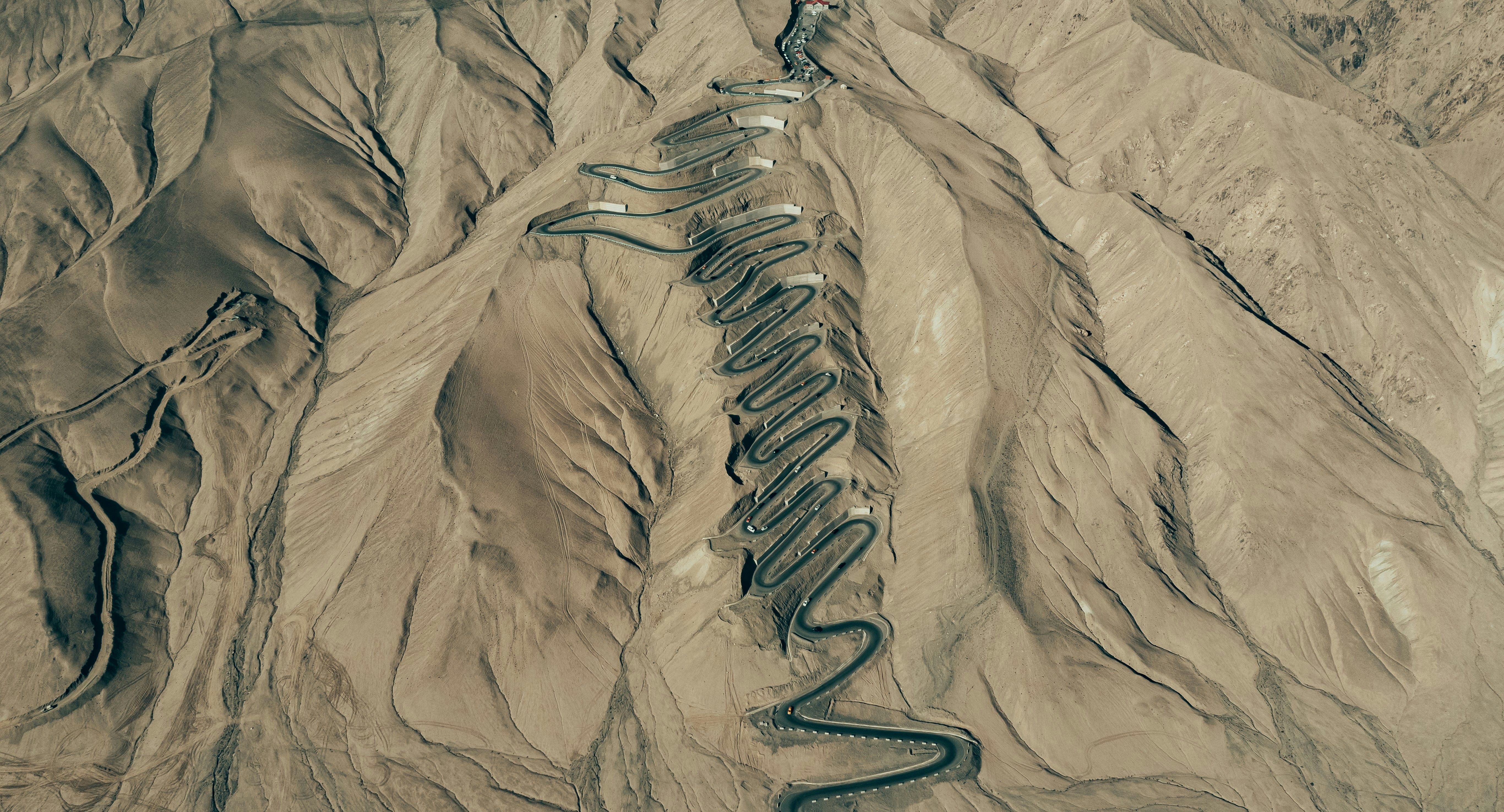 An aerial view of a mountain range with a snake photo – Free Image on ...
