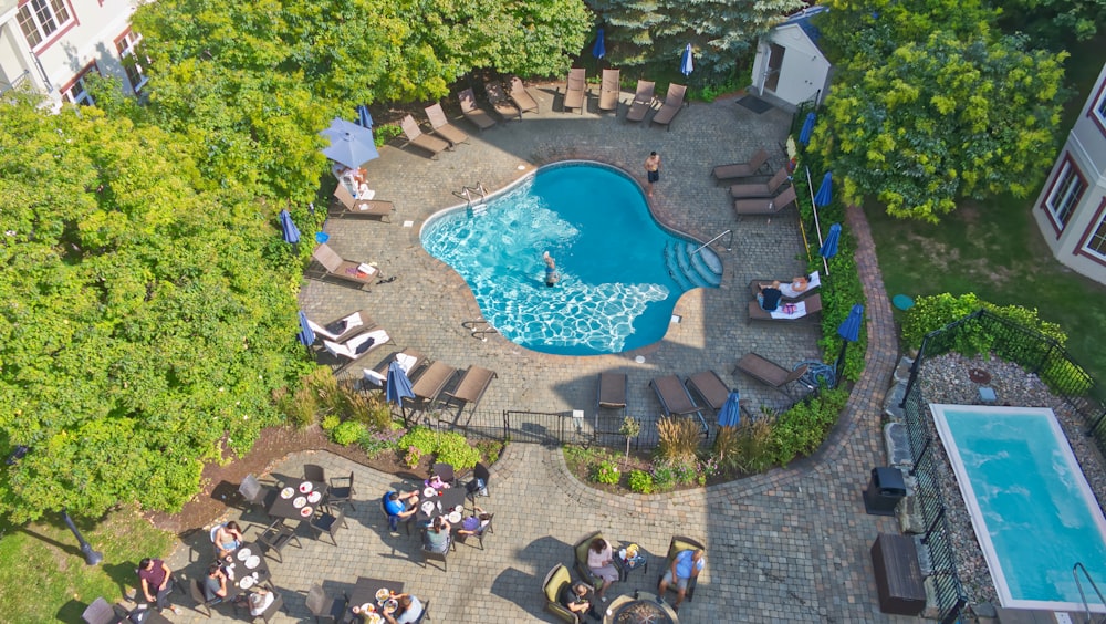 an aerial view of a pool surrounded by lounge chairs