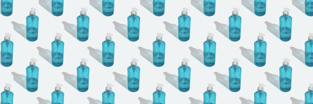 a group of blue bottles sitting next to each other