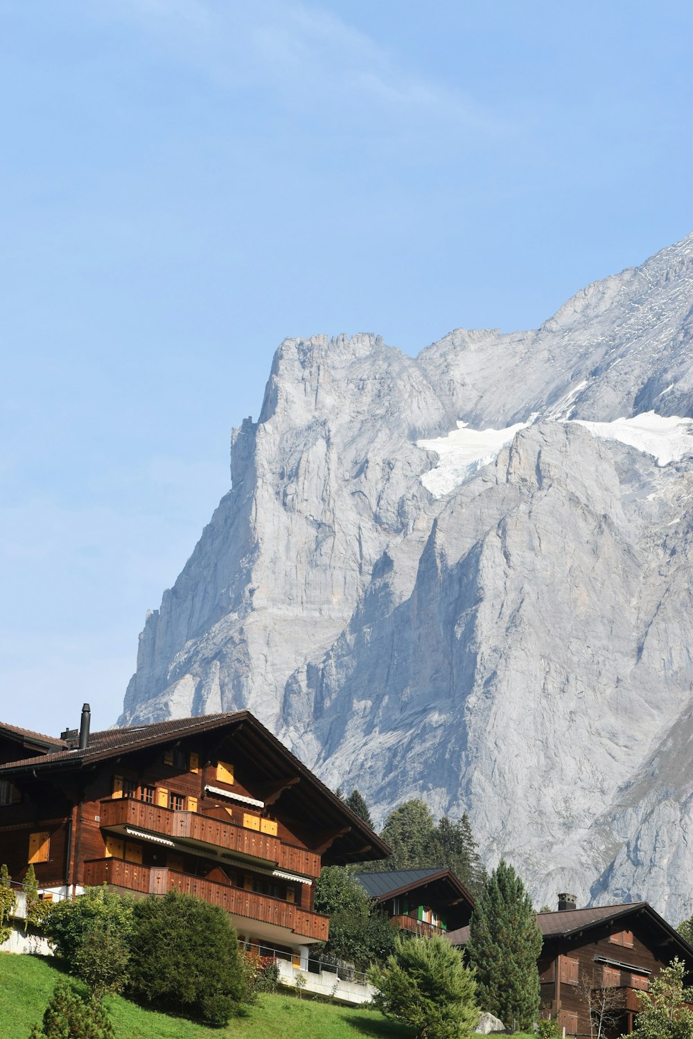 a large mountain with a house in the foreground