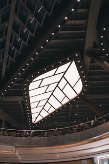 A modern dining area showcasing a ceiling with geometric patterns and integrated LED strips.