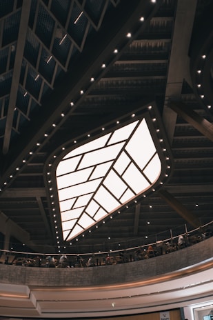 A modern dining area showcasing a ceiling with geometric patterns and integrated LED strips.