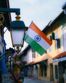 an indian flag hanging from a street light