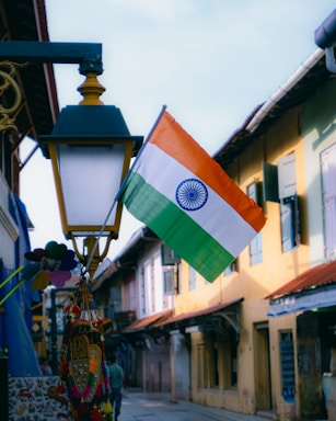 an indian flag hanging from a street light