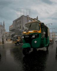 A Kinetic Green electric three-wheeler delivering goods in the bustling streets of Machilipatnam.