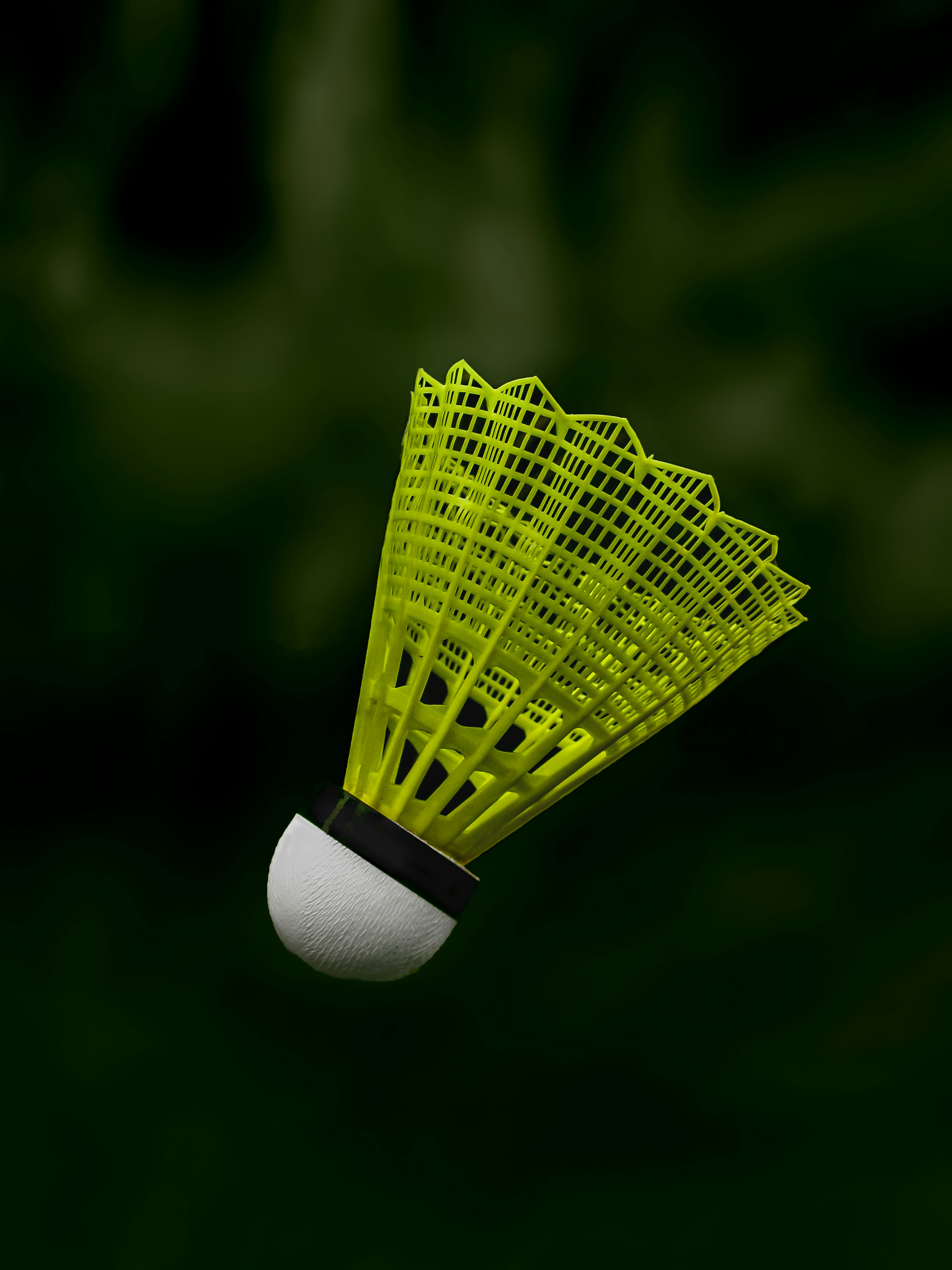 a yellow badminton racquet flying through the air