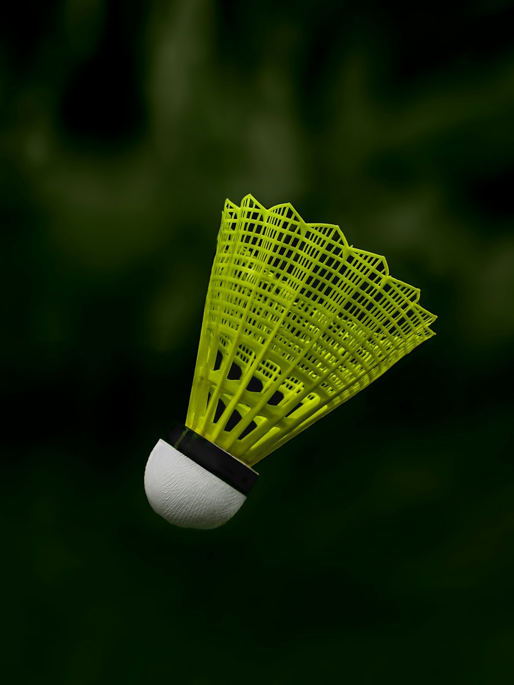 a yellow badminton racquet flying through the air