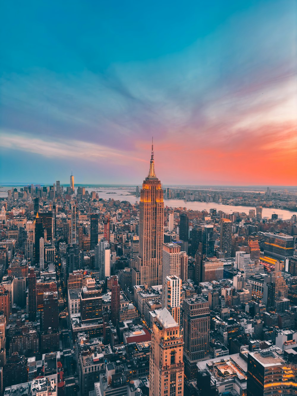 an aerial view of a city at sunset