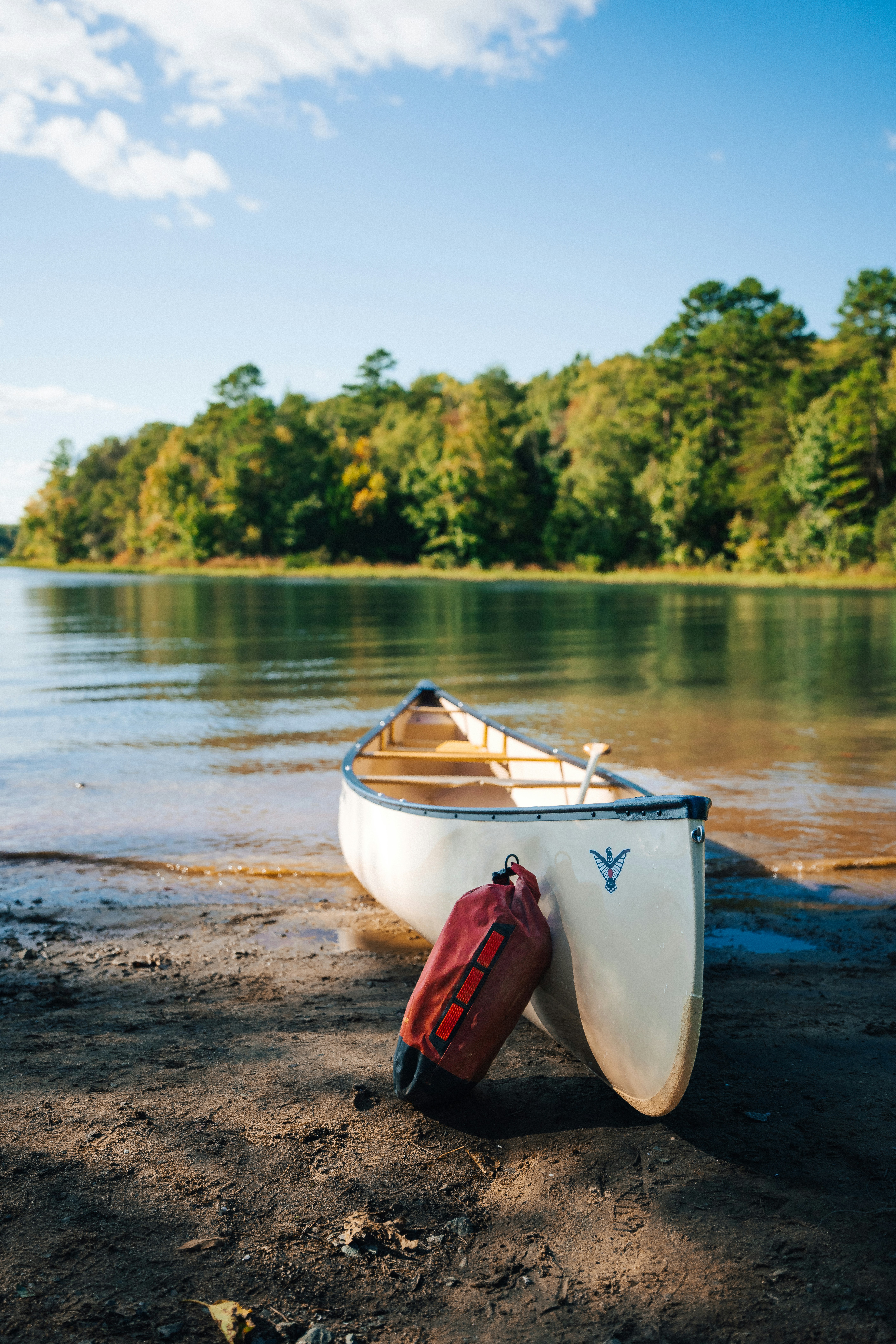 a small white boat sitting on top of a sandy beach