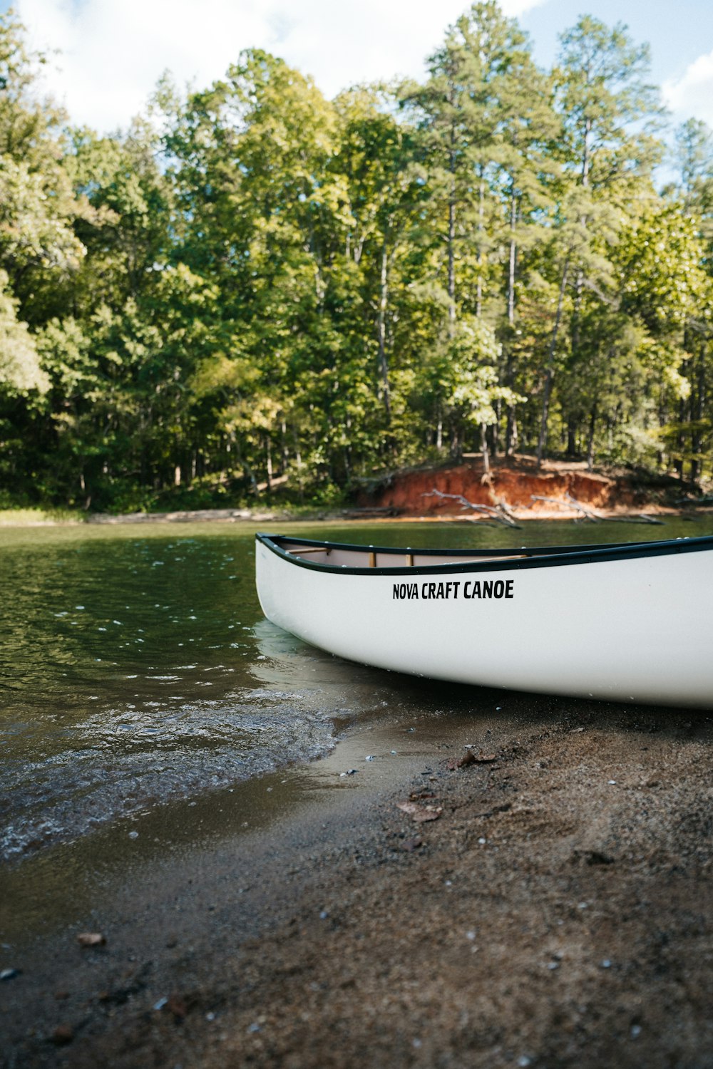 a canoe sitting on the shore of a lake