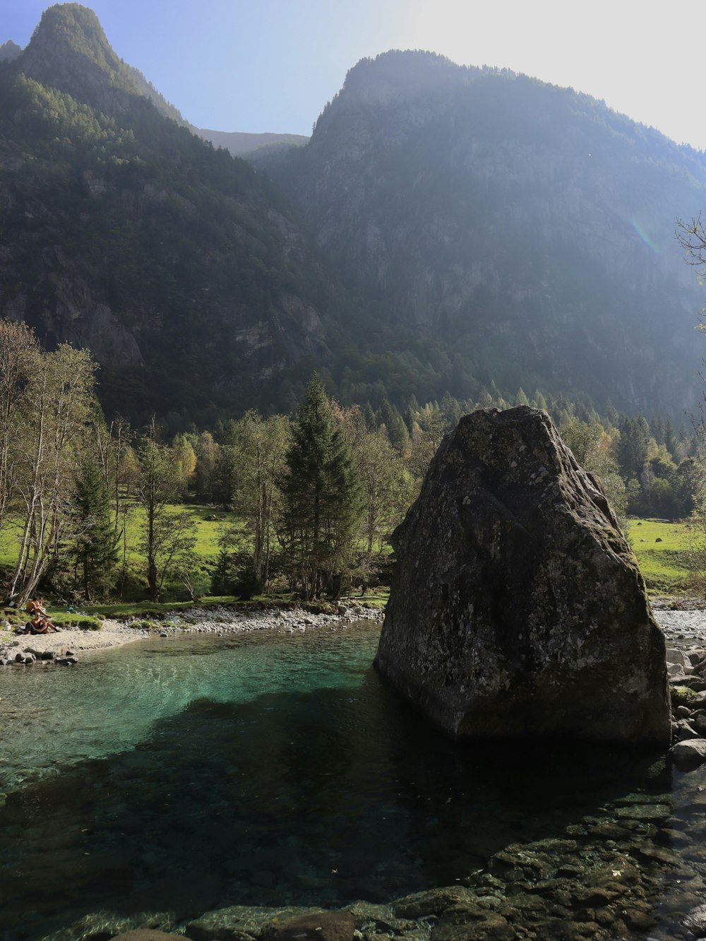 a large rock sitting in the middle of a river