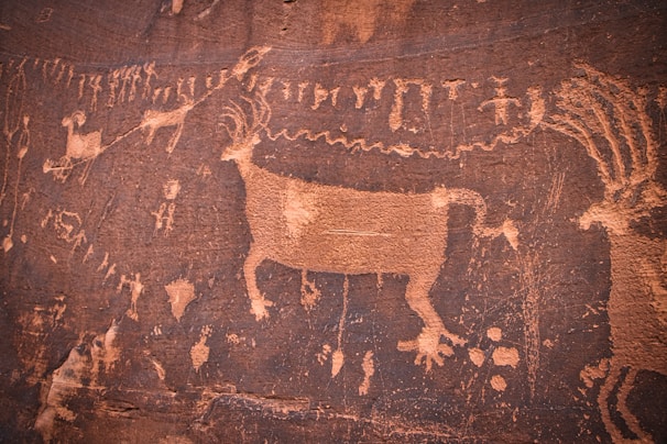 a painting of a cow on a rock wall
