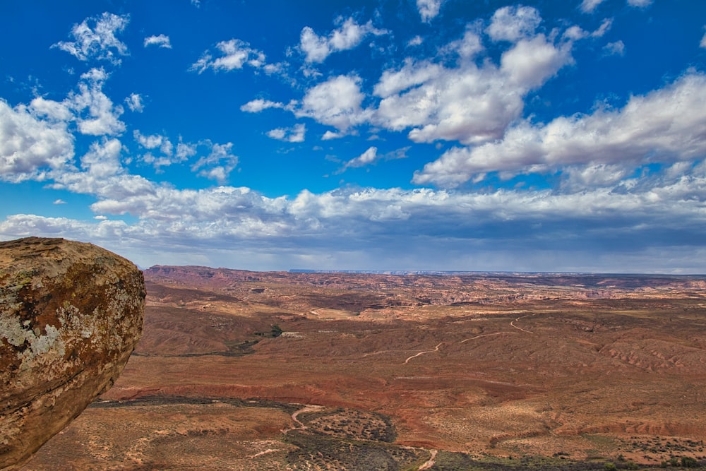 una persona seduta sulla cima di una grande roccia