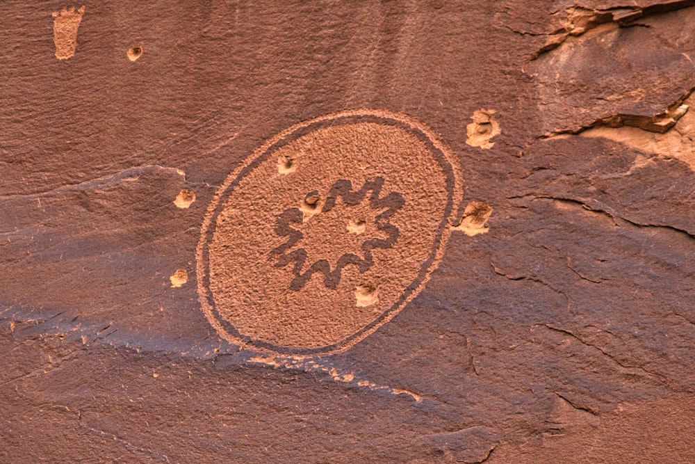 a rock with a drawing of a flower on it