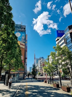 A sidewalk robot navigating a bustling urban street with pedestrians passing by