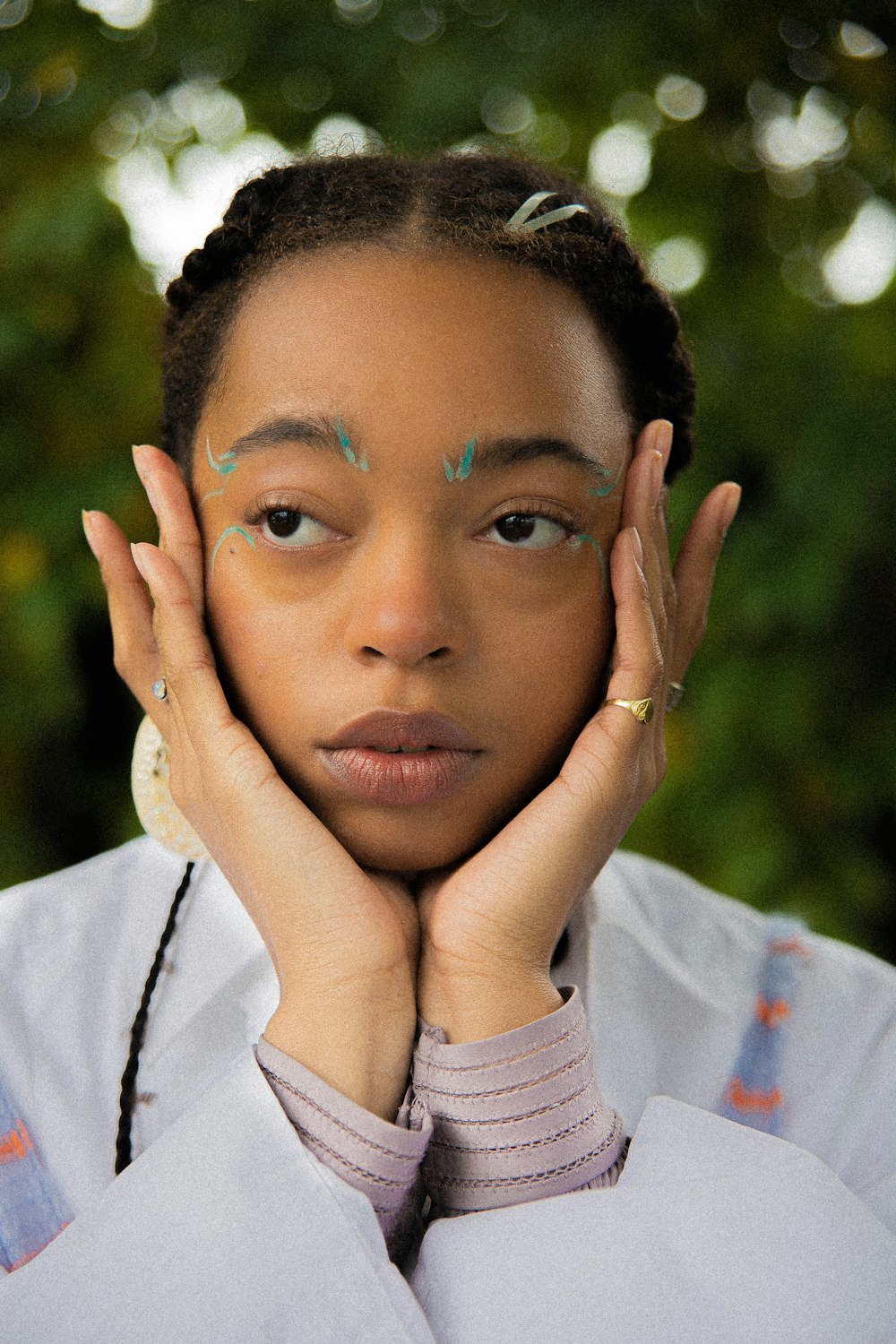 a woman with her hands on her face