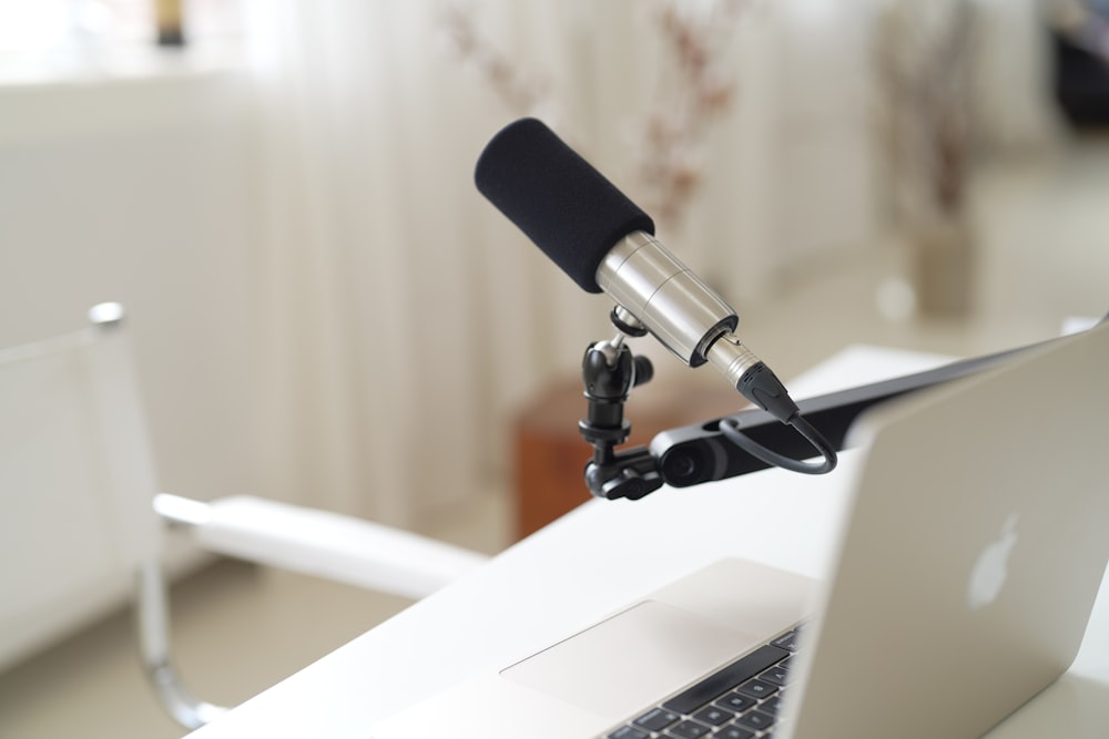 a microphone attached to a laptop computer on a desk