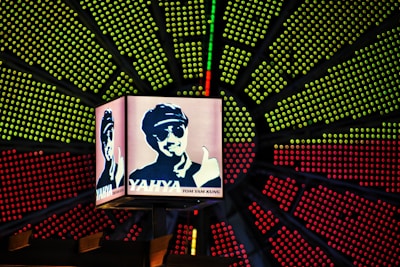 A colorful LED screen displaying a lively local business advertisement in Theni.