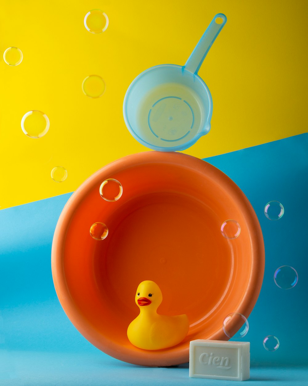 a yellow rubber duck in a red bowl