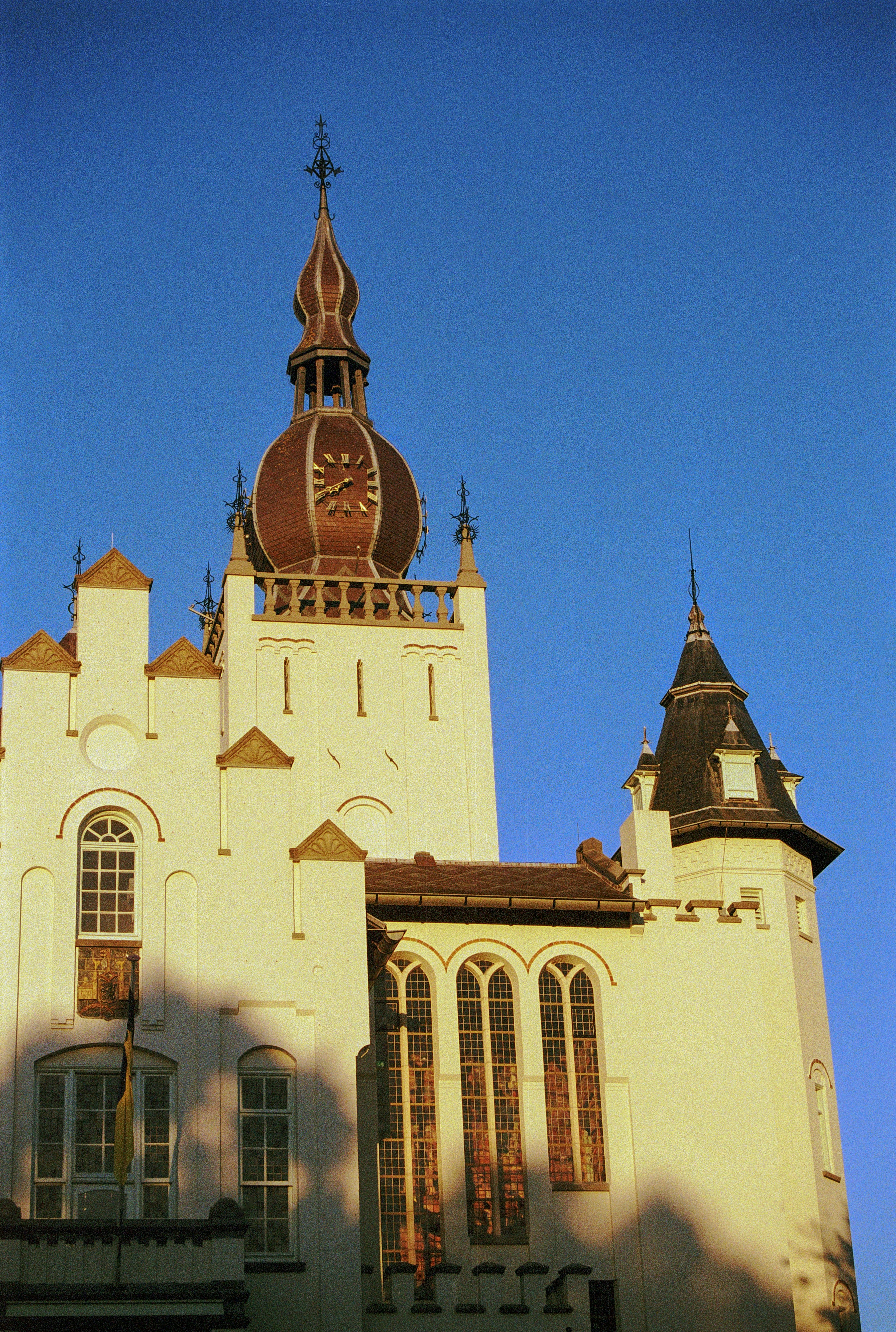 a large white building with a clock on the top of it