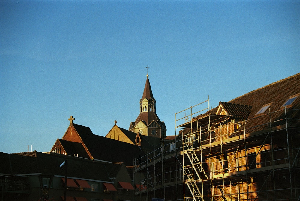 a building with scaffolding around it and a clock tower in the background