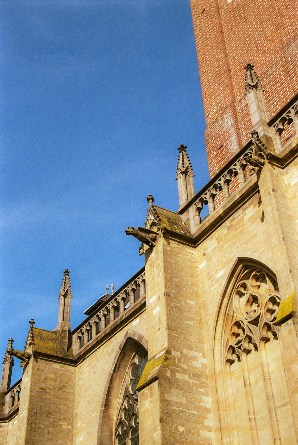 a tall brick building with a clock on it's side