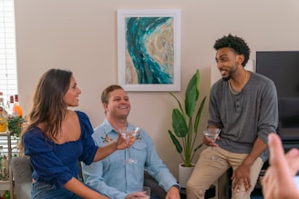 a group of people sitting around drinking wine