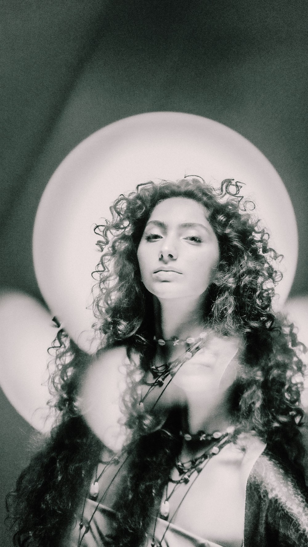 a black and white photo of a woman with curly hair