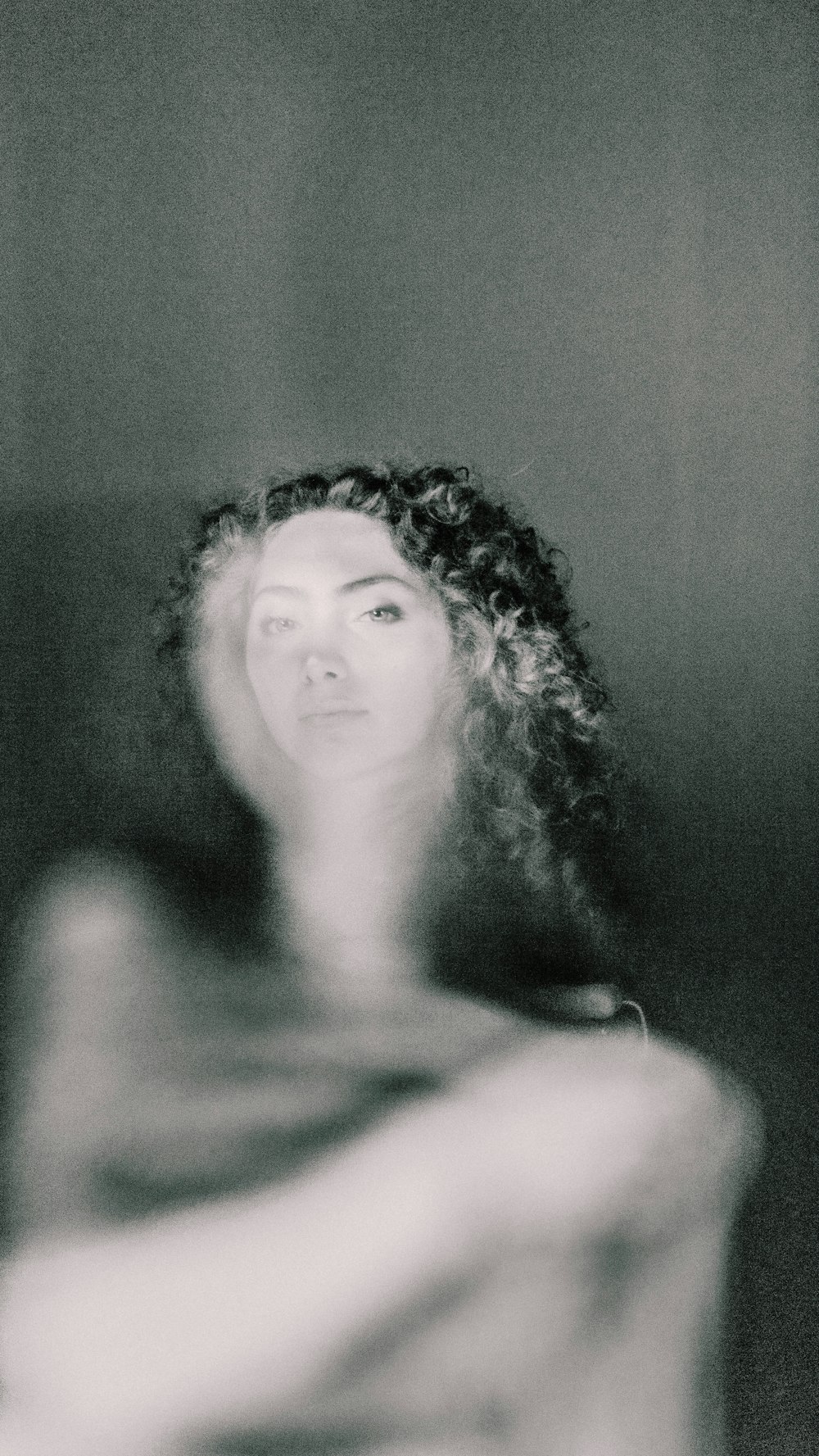 a black and white photo of a woman with curly hair