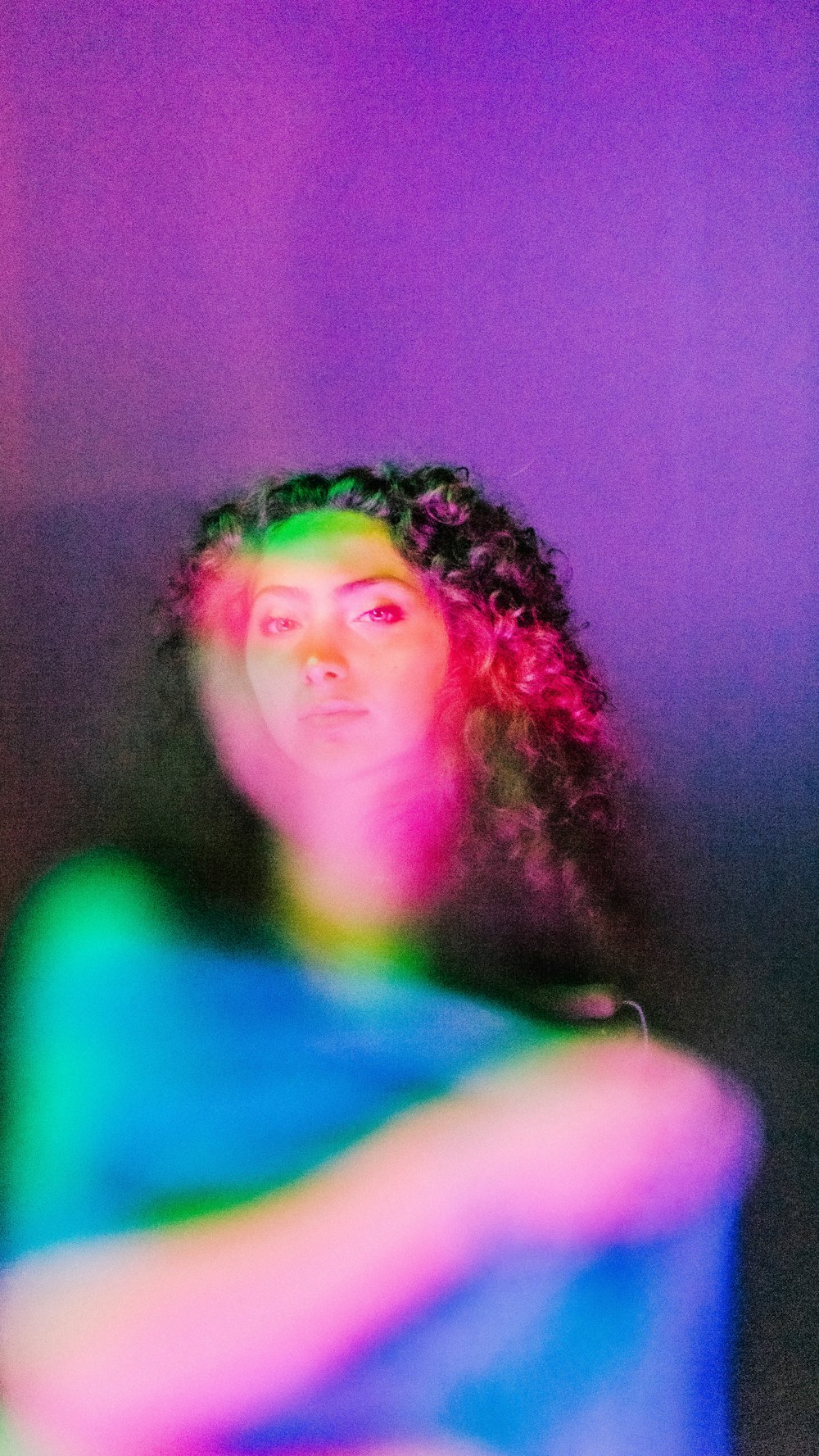 a woman with curly hair is sitting in a chair