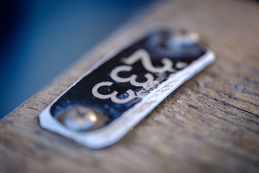 a close up of a key chain on a wooden surface