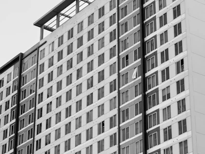 Monochrome sketch of a modern apartment building with large windows.