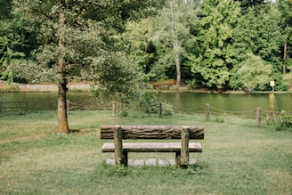 A peaceful outdoor scene with a journal and pen resting on a bench, inviting reflection.