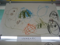 A child proudly showing a drawing symbolizing their emotions after a coaching session.