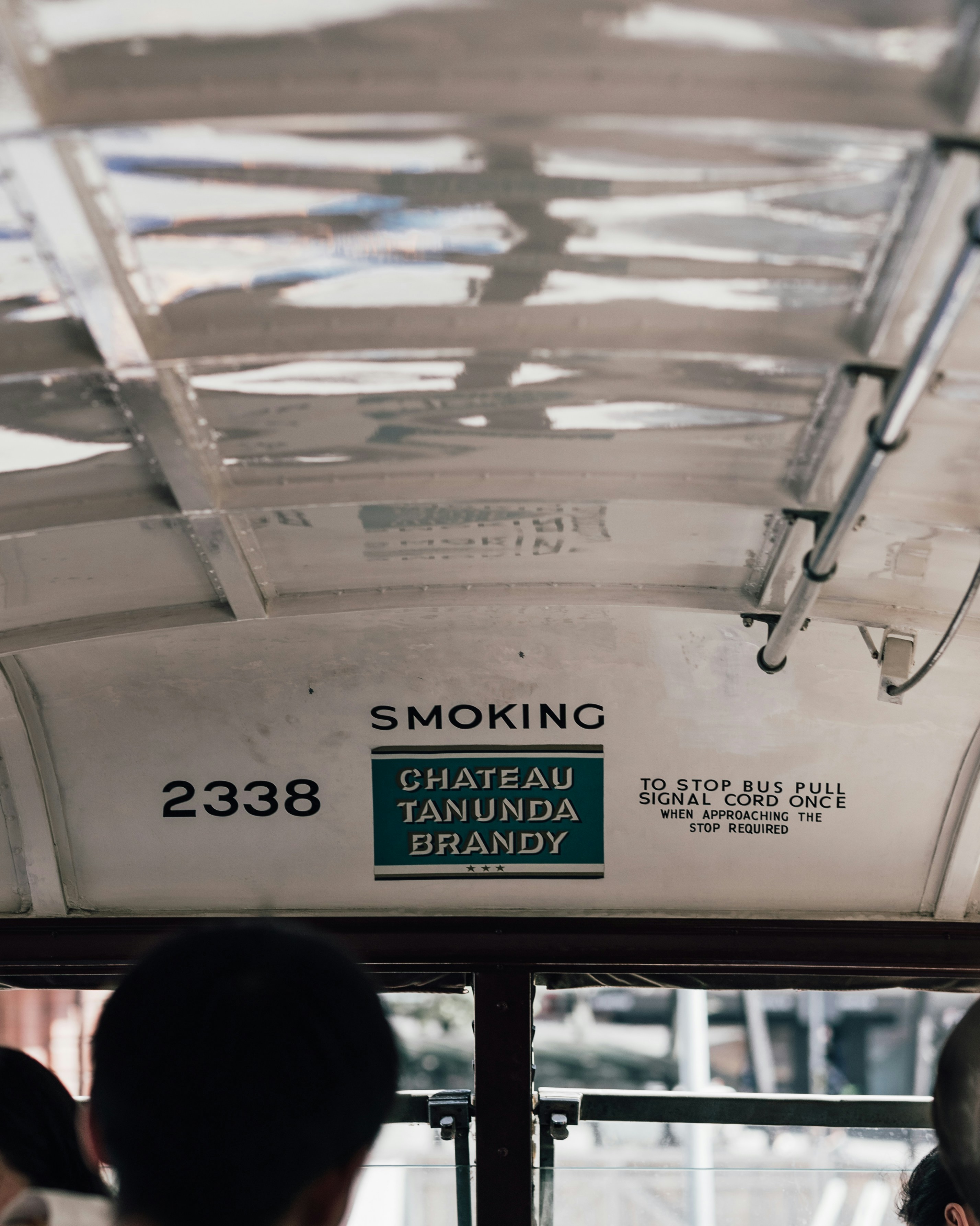 there is a sign on the ceiling of a bus