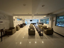 A cozy seating area with plush chairs and ambient lighting, inviting guests to relax and enjoy their coffee.