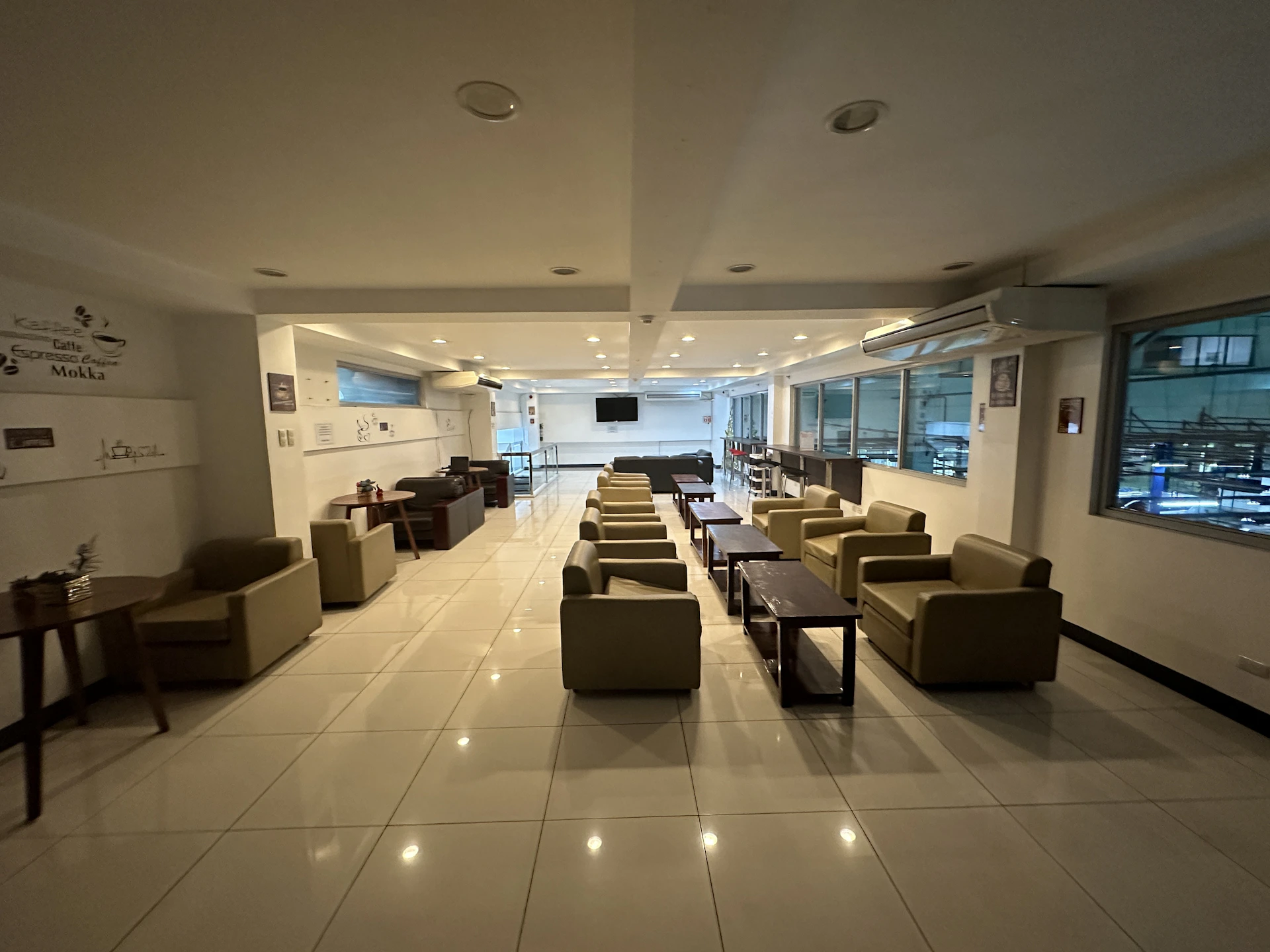 Guests enjoying a relaxed moment in the hotel’s cozy shared lounge area, with tasteful décor and soft ambient lighting.