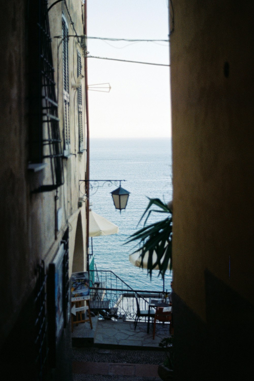 a view of the ocean from an alley way