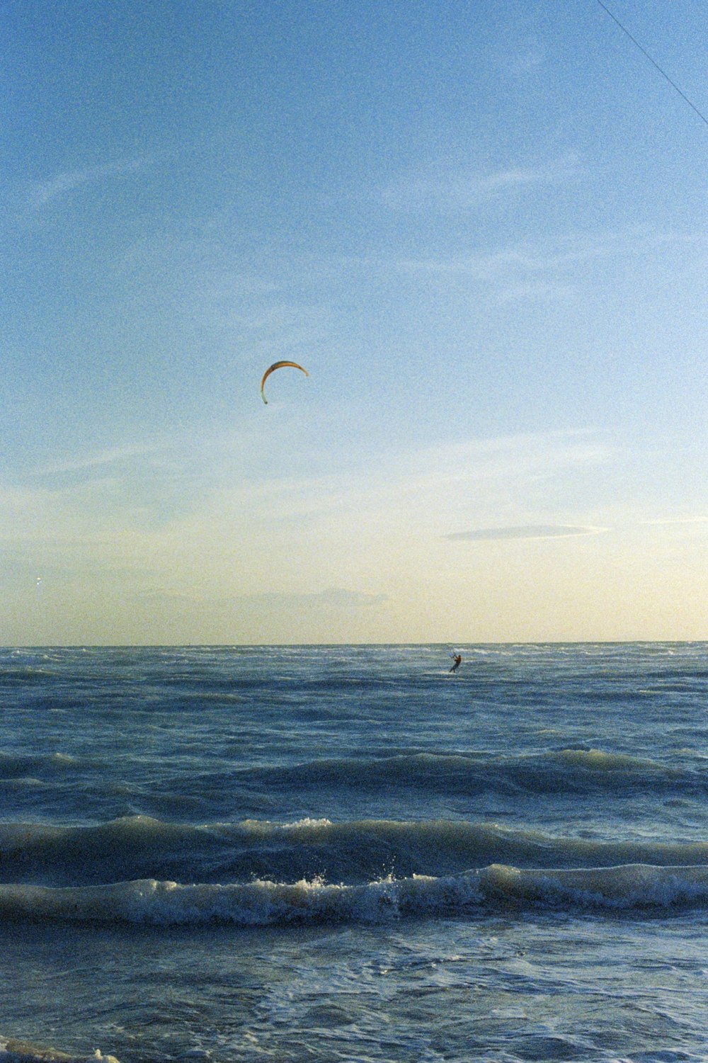 a person para sailing in the ocean on a sunny day