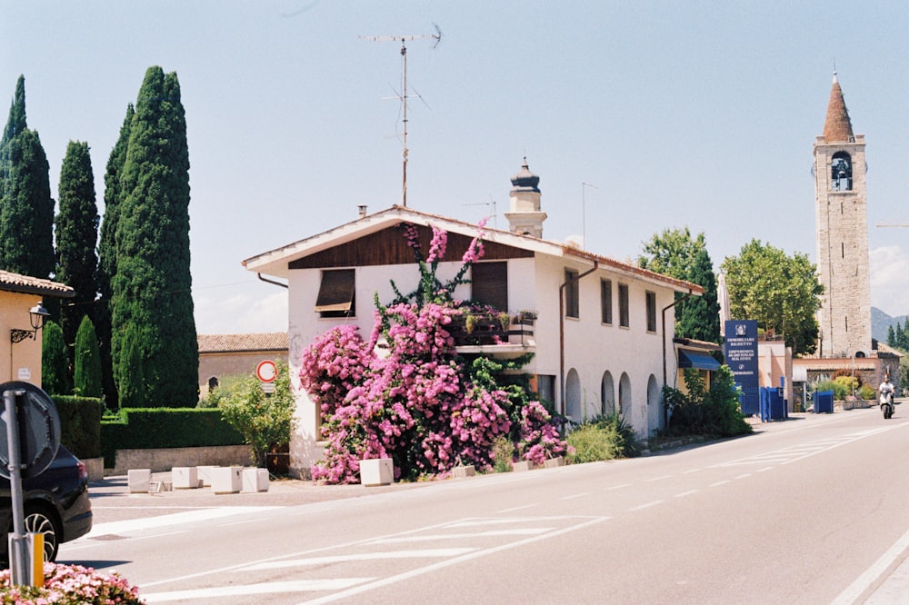 a street with a building and a clock tower in the background