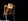 a yellow and black robot standing in the dark