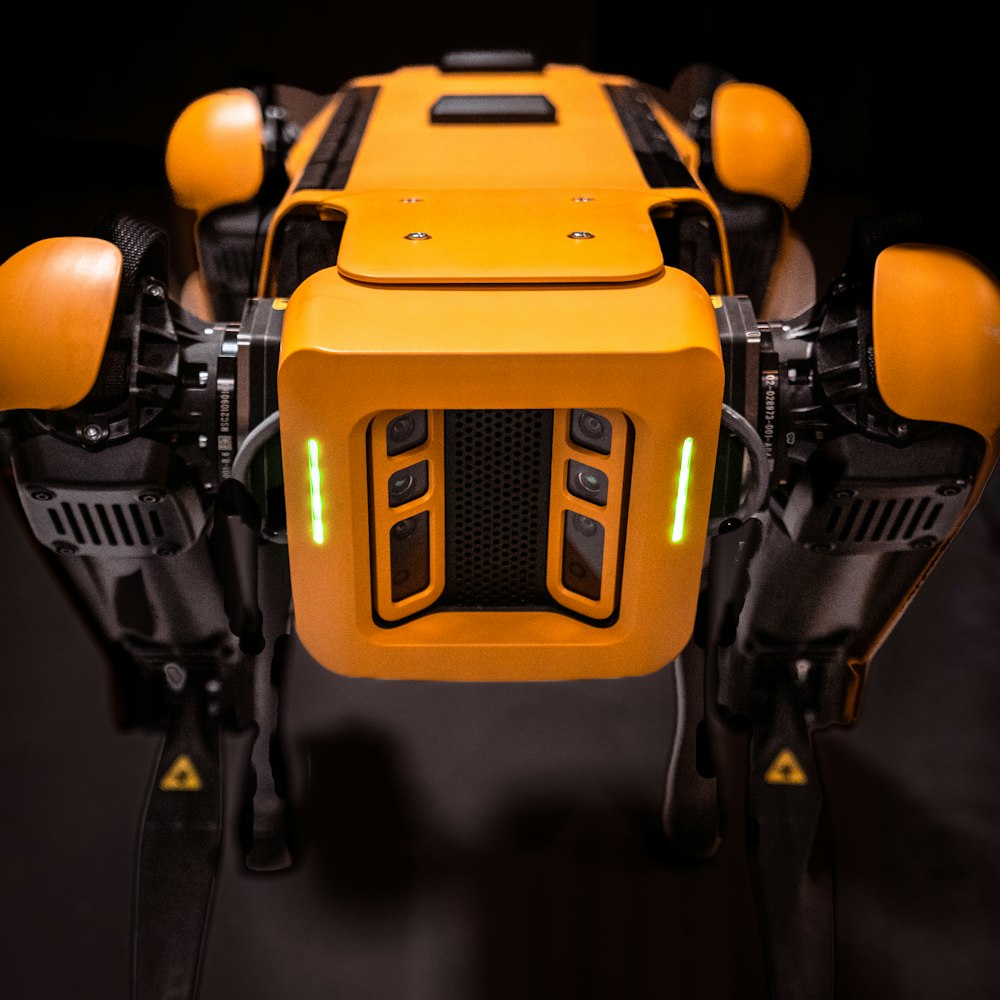 a close up of a robot that is yellow and black